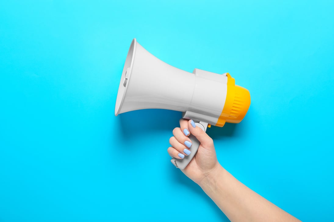 Woman with Megaphone on Color Background